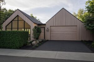 Contemporary residential architecture in Googong featuring timber cladding, dual pitched roofs, and modern kitchen interiors.
