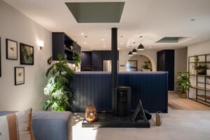 Mid-century modern blue kitchen design in Canberra with bold cabinetry, light benchtops, and functional layout.