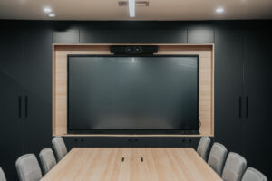 Corporate office meeting rooms in Canberra featuring dark acoustic wall panels and functional layouts.
