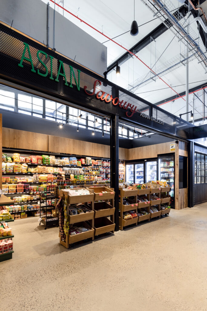 AsianSavoury-9 Modern grocery fitout in Canberra featuring green walls, warm timber finishes, and polished concrete flooring.