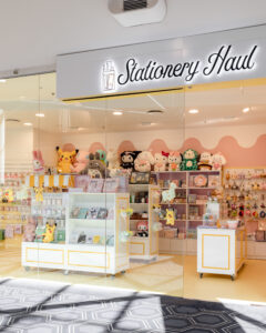 Colourful retail fitout in Westfield Belconnen featuring bright yellow and pink walls with creative merchandising.
