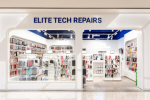 Modern tech repair shop fitout in Canberra featuring white perforated metal walls and a bold blue ceiling.