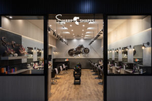 Industrial-inspired barber shop fitout in Tuggeranong, Canberra featuring bold detailing and custom motorbike display