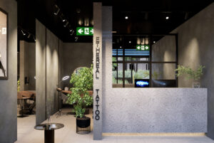 Industrial tattoo studio fitout in Canberra featuring exposed concrete, raw materials, and urban styling.